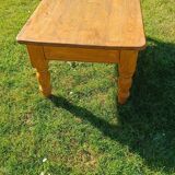 Solid oak coffee table with turned legs.