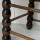 Brutalist wood turned bobbin rush stool in the style of Charles Dudouyt