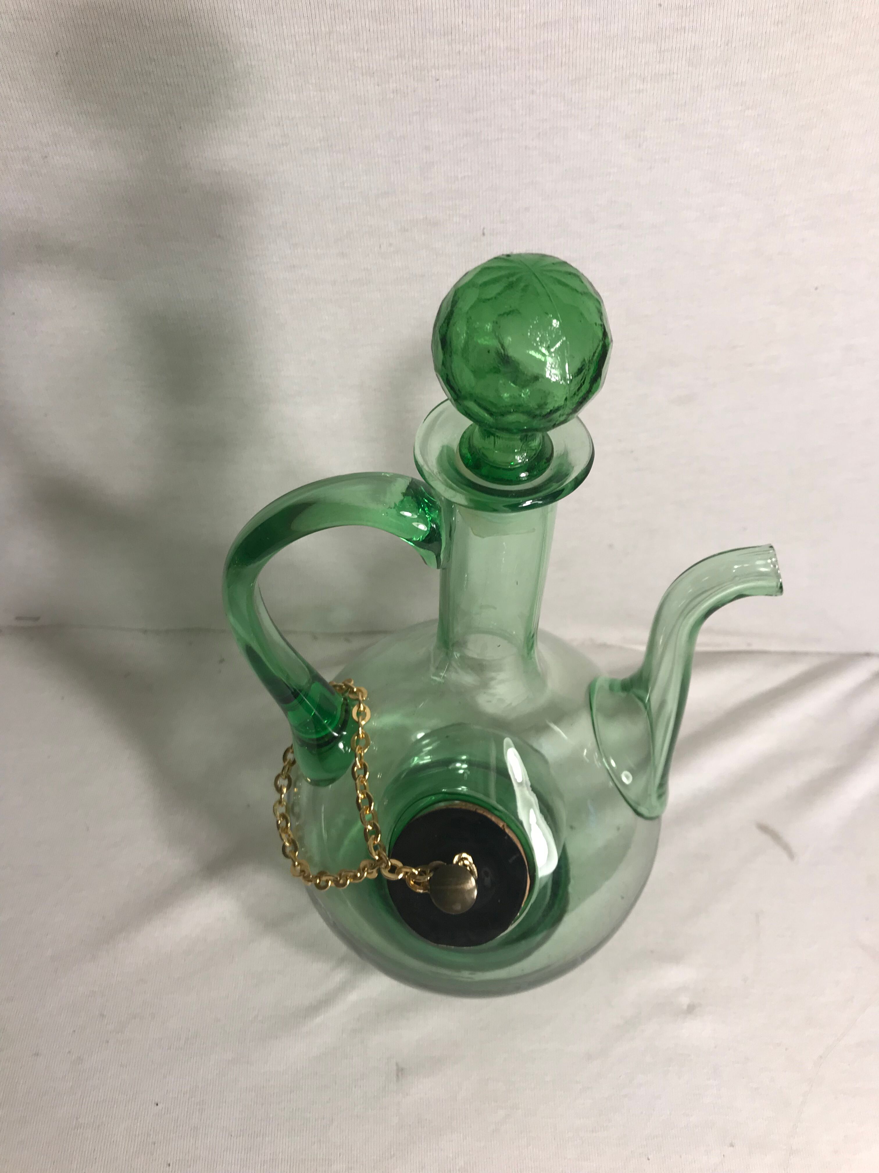 Old refreshing carafe pourer in green blown glass with vintage cap