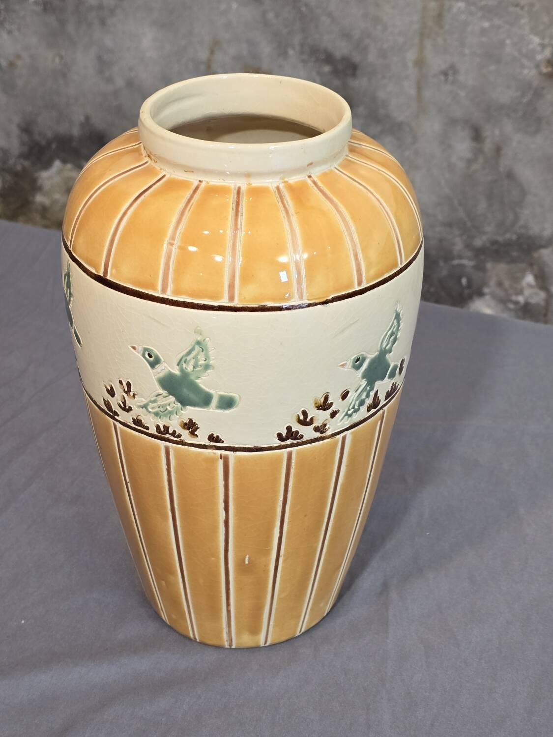 Orange and green ceramic vase with duck motif