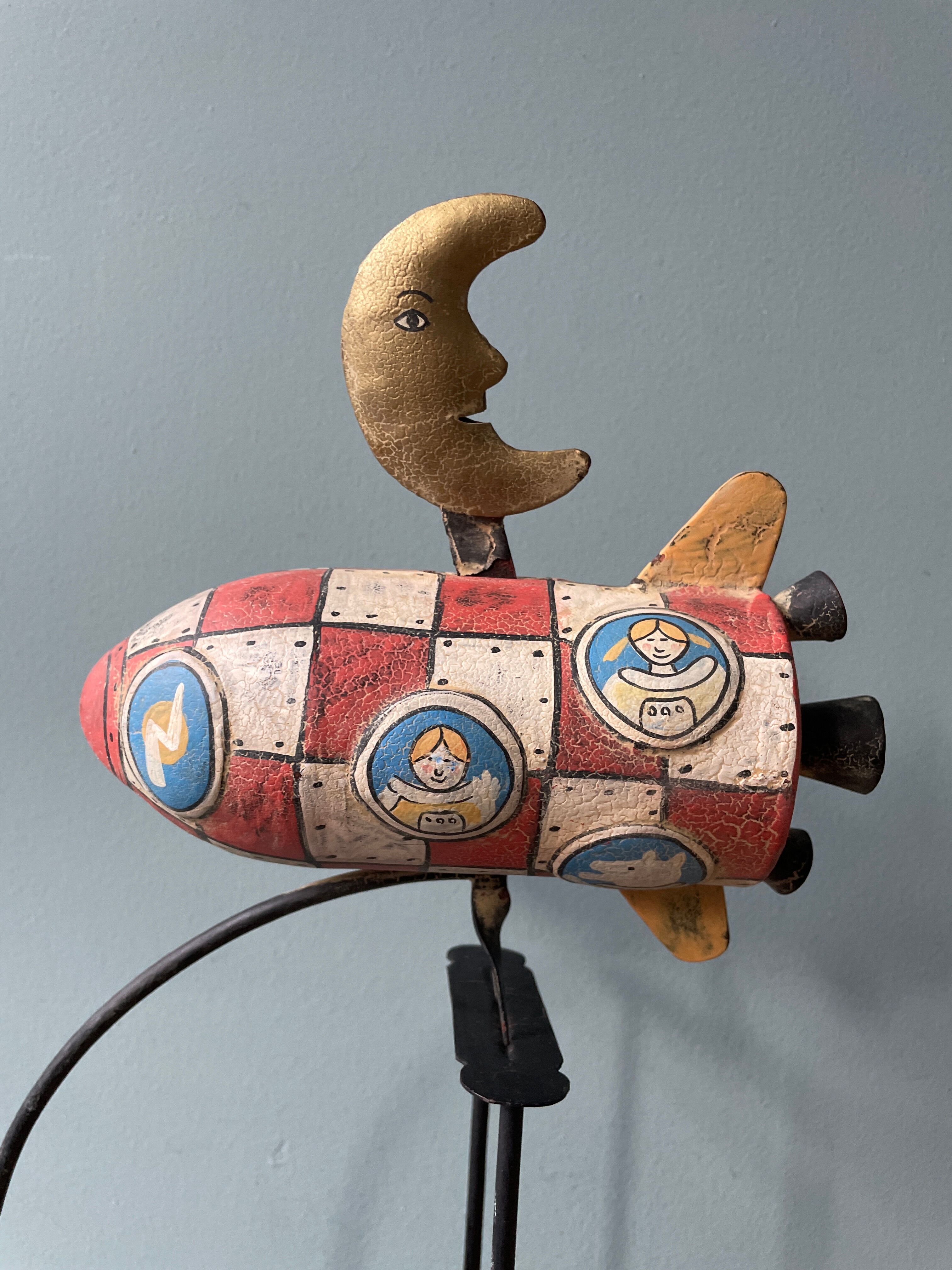 Old painted sheet metal pendulum toy