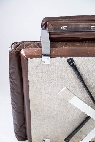 Easy chair upholstered with patinated brown leather and frame in metal, designed by Arne Norell