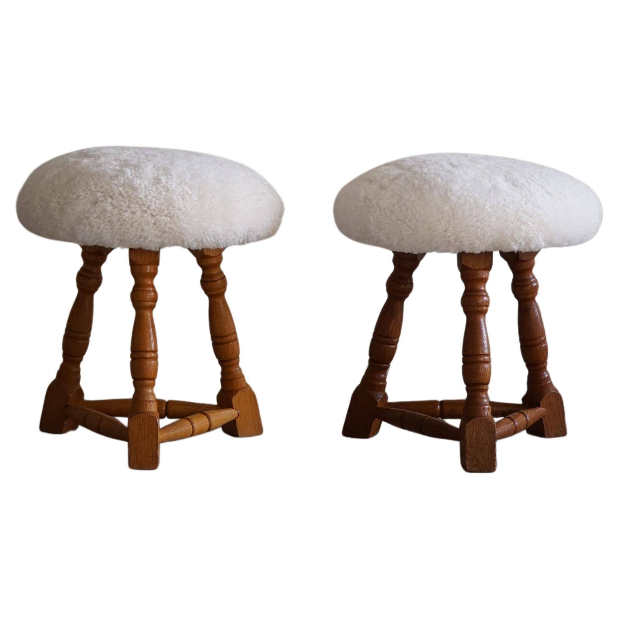 Modern Danish, a pair of tripod stools, seats reupholstered in lambswool, 1950s.