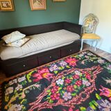 Bohemian floral design, handwoven wool rug, black background with colorful flowers