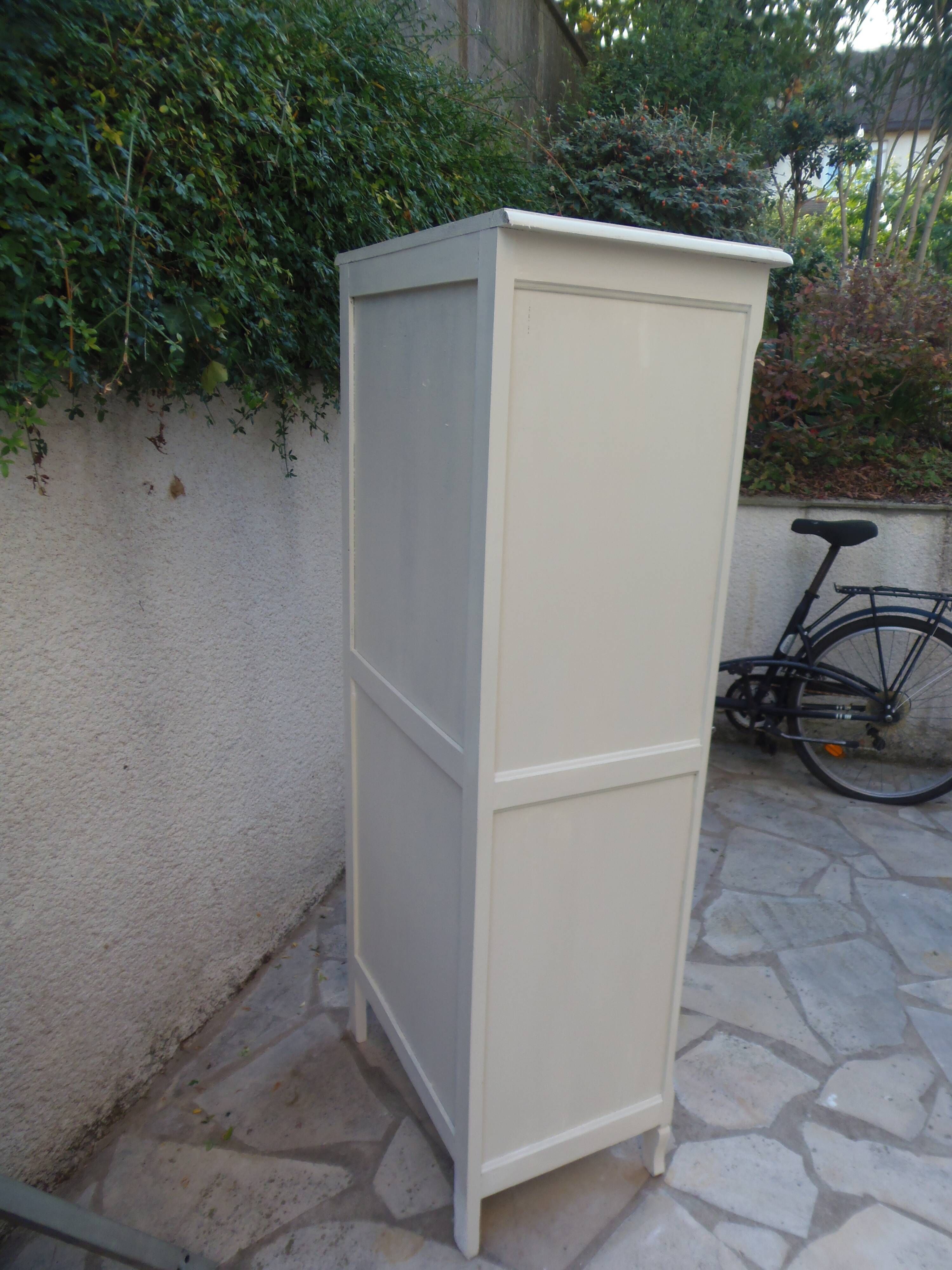 Vintage beige wardrobe made of wood and jute fabric.