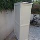 Vintage beige wardrobe made of wood and jute fabric.