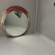 Vintage round mirror with an industrial metal frame in a painted finish.