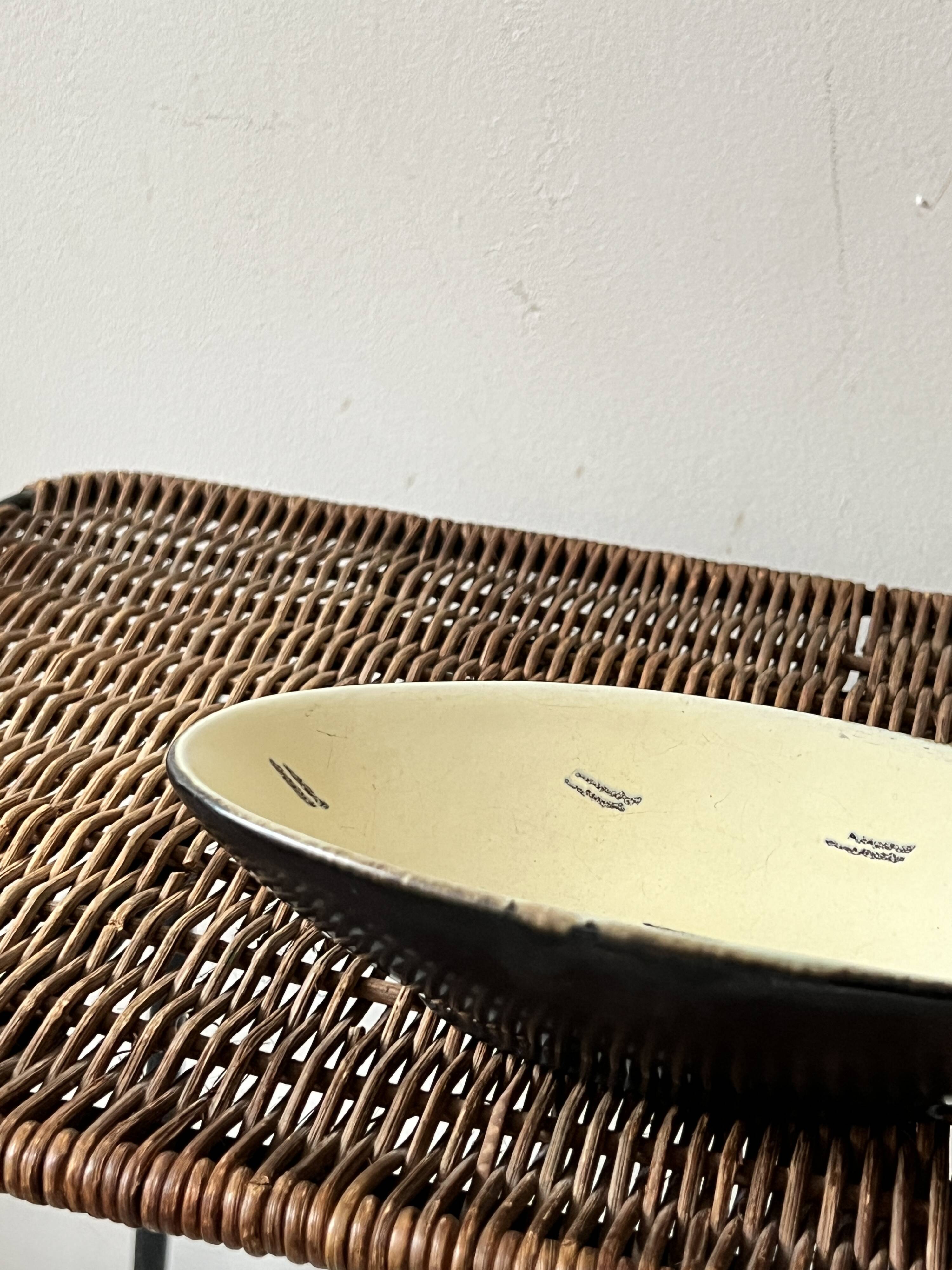 Pale yellow and black ceramic bowl / empty pocket signed by the artist