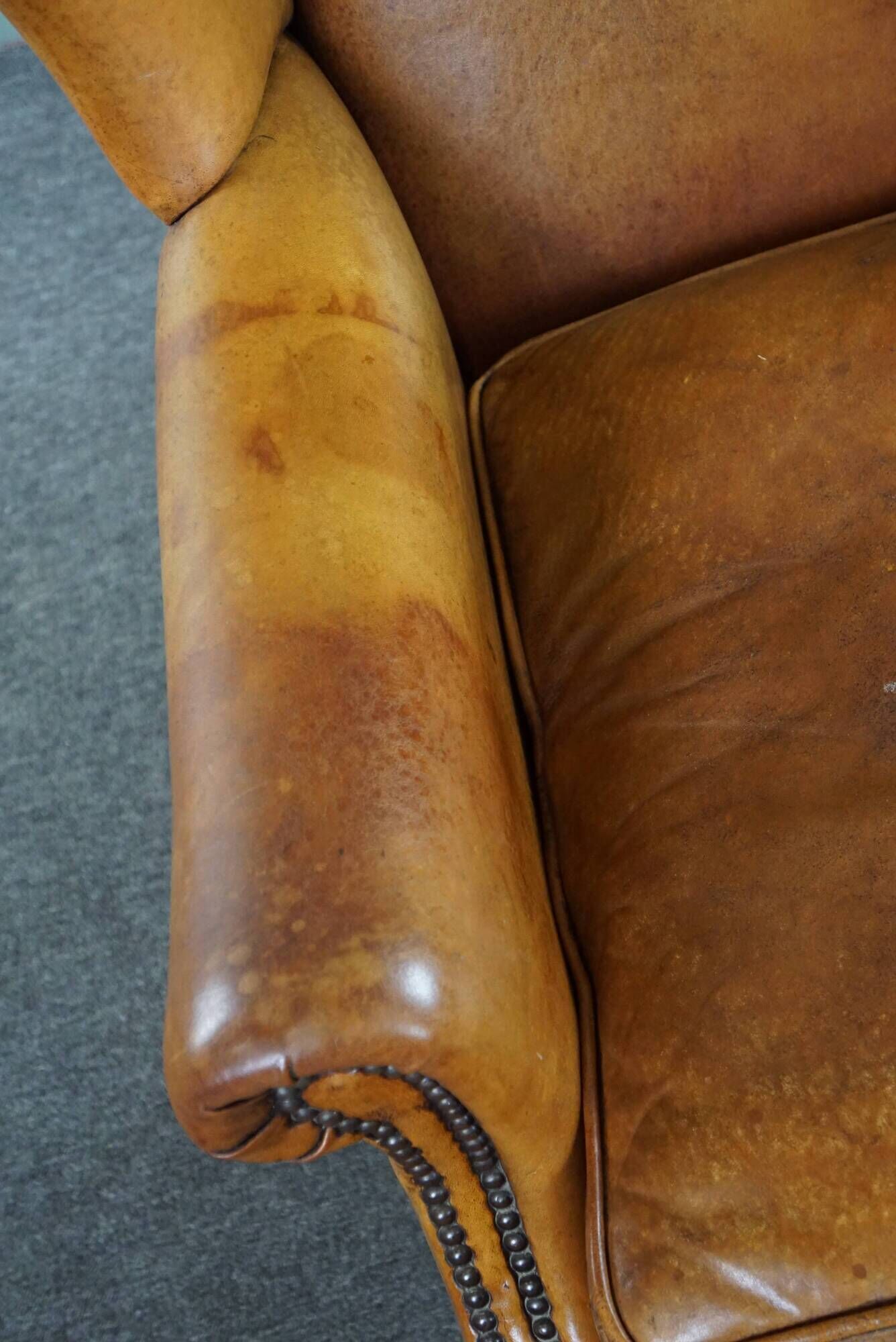 Wingback chair made of sheepskin leather in a light honey color