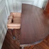 Family half-moon table in walnut hue.