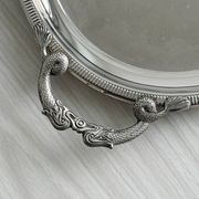 Large stainless steel serving platter with fish-shaped handles.