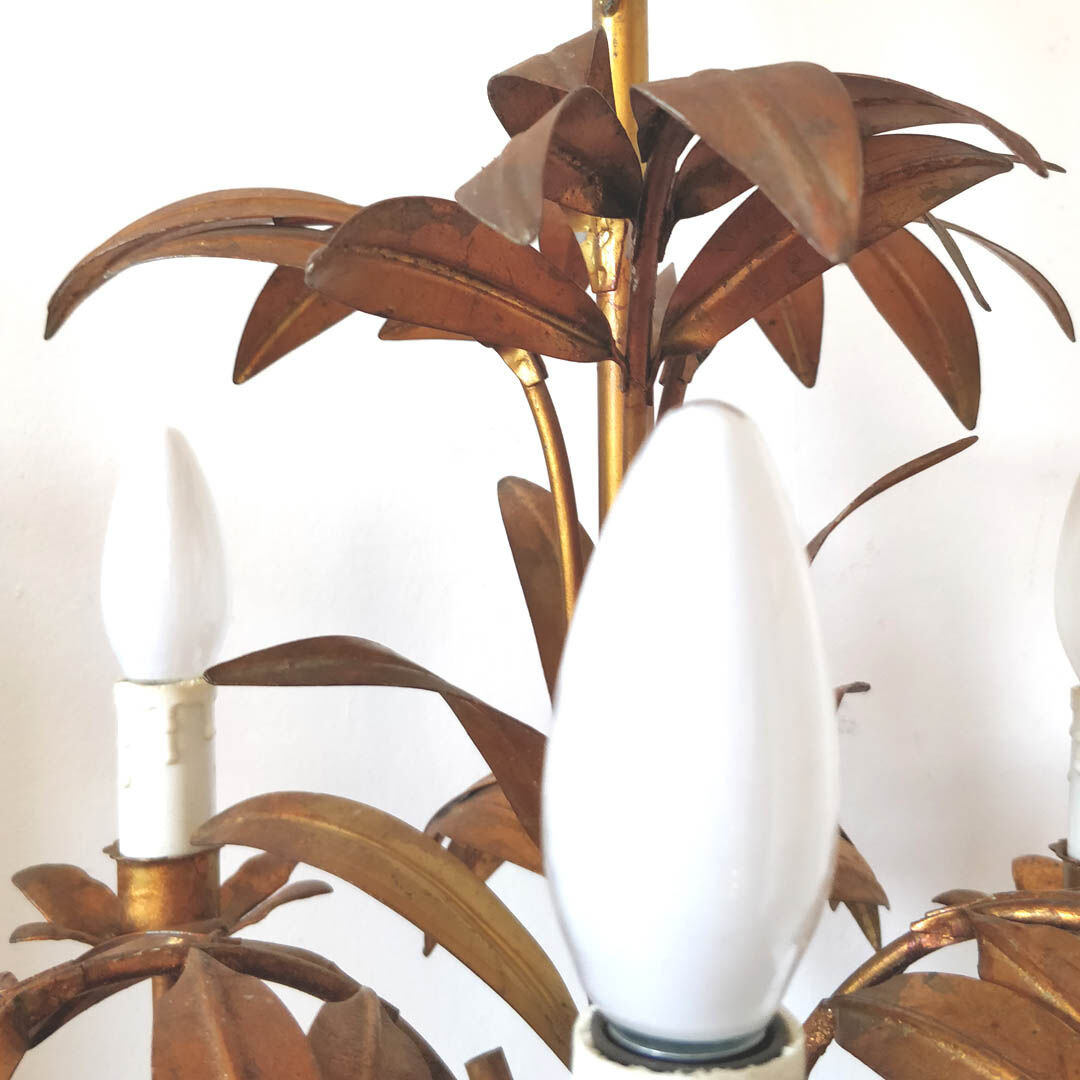 Golden metal chandelier palm leaves