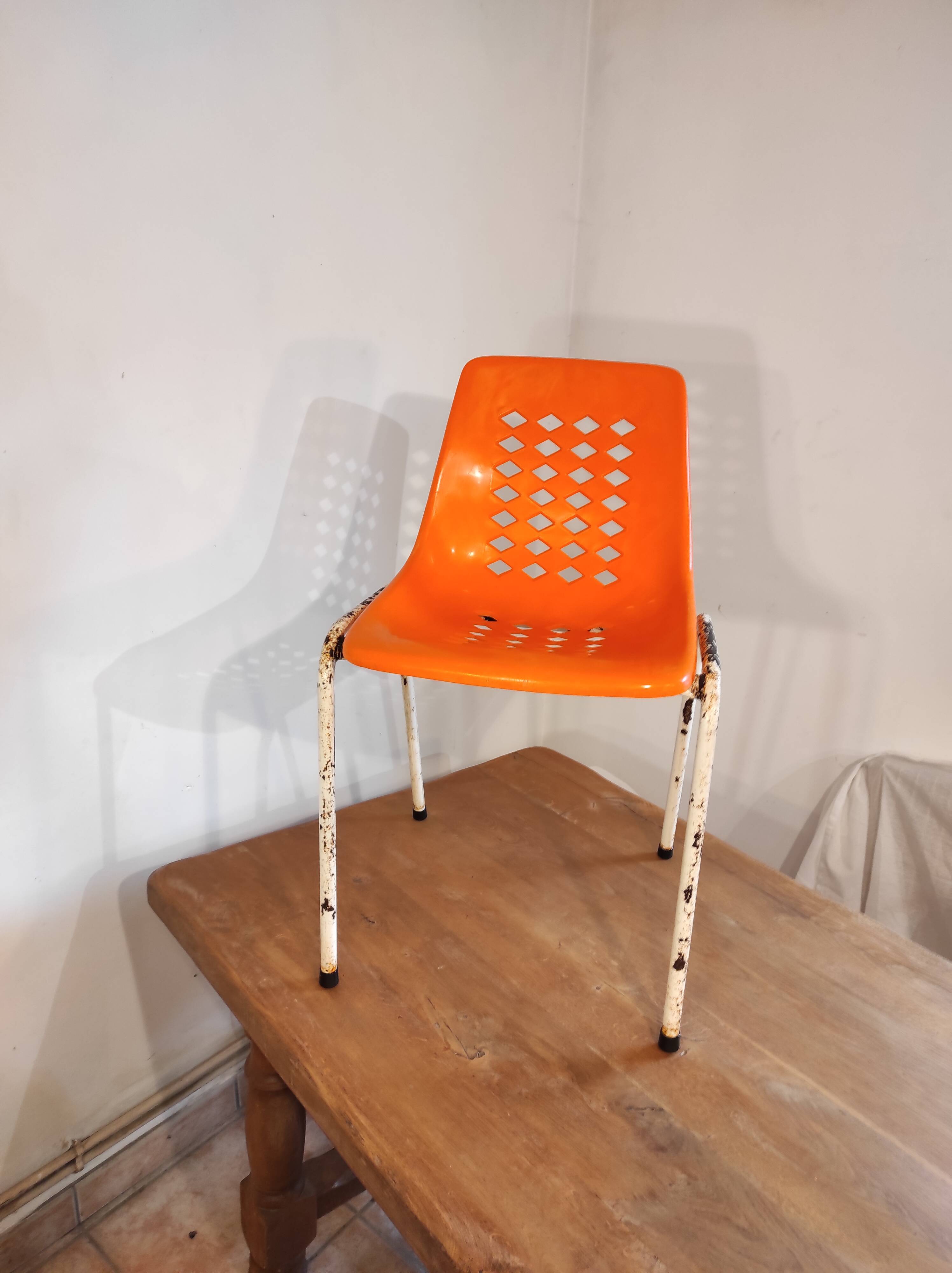 Chair with openwork plastic shell 1970