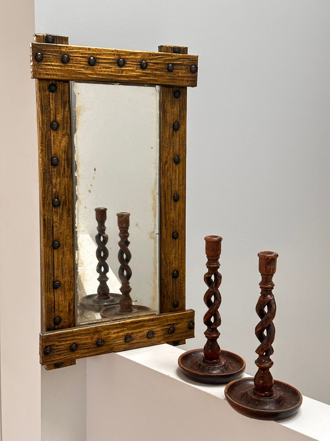 Brutalist mirror with a hammered copper and brass frame.