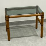 Blonde wood coffee table with smoked glass and leather bindings.