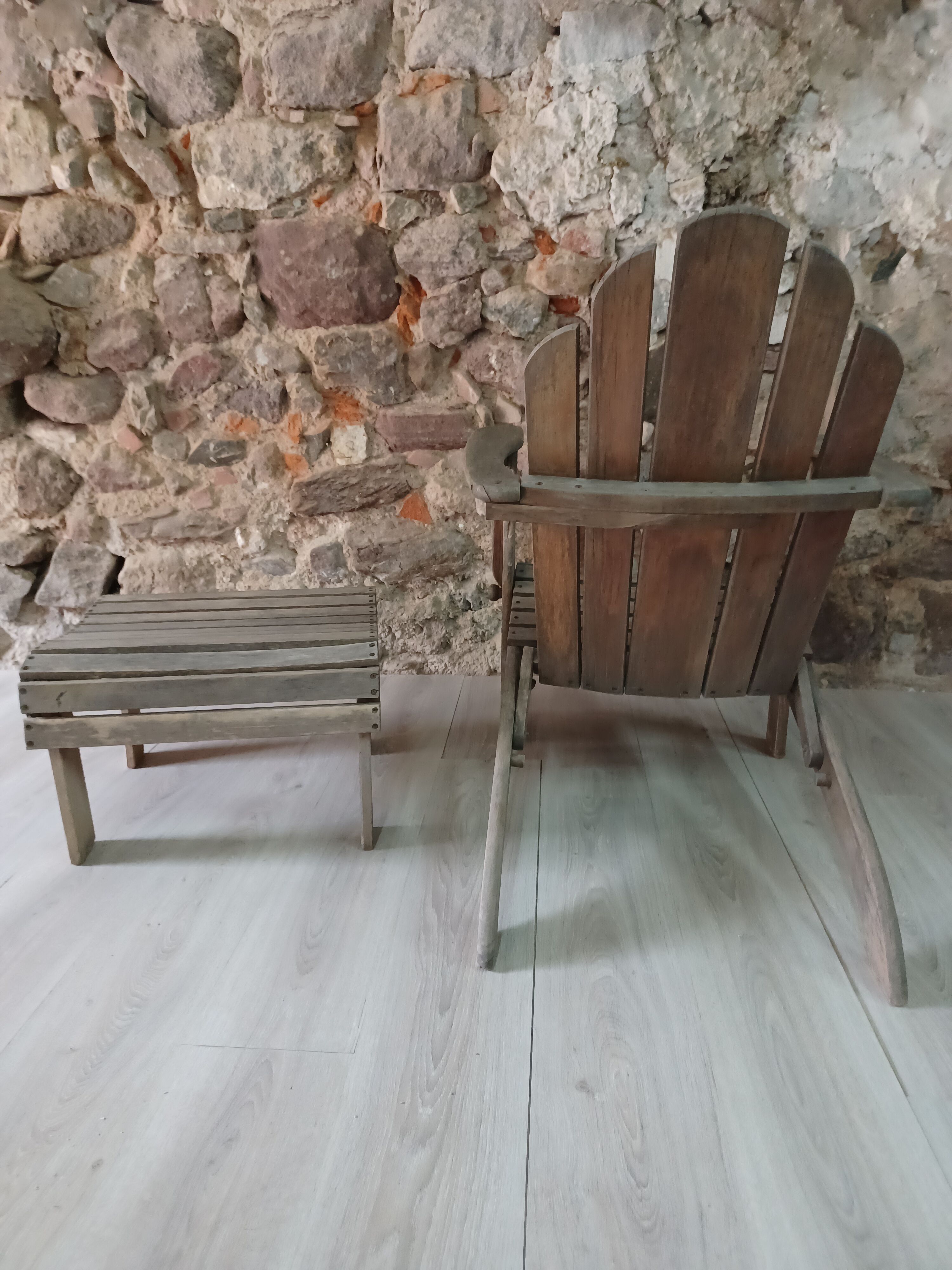 Ancient Adirondack armchair with footrest