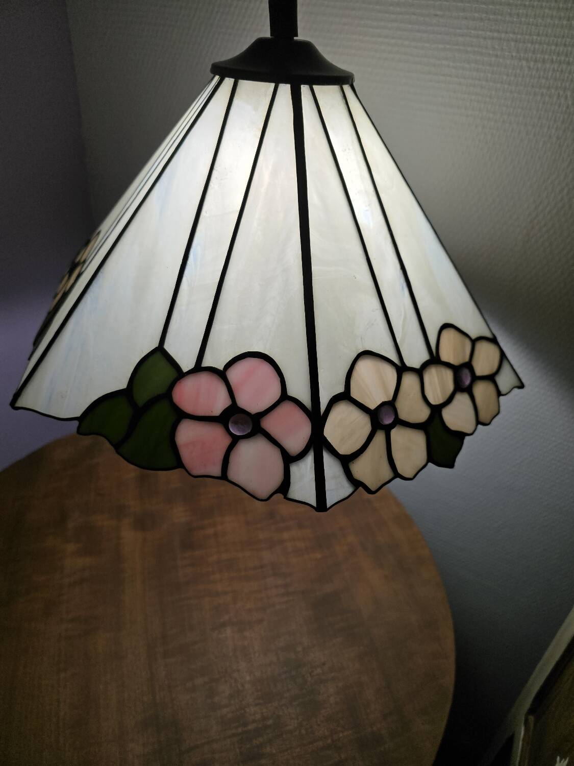 Tiffany-style stained glass lampshade with floral motifs.