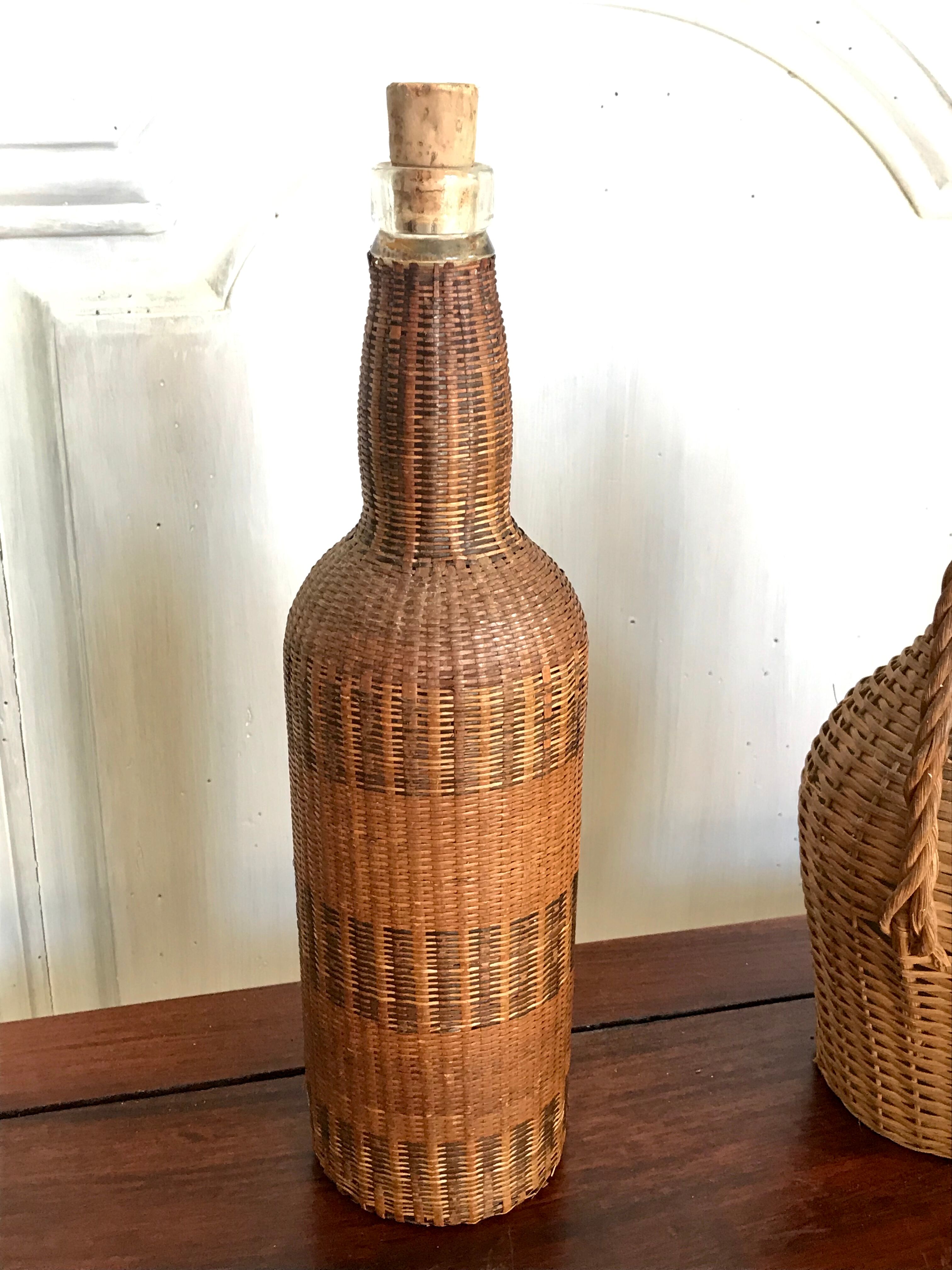 Set of three vintage rattan bottles