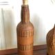 Set of three vintage rattan bottles