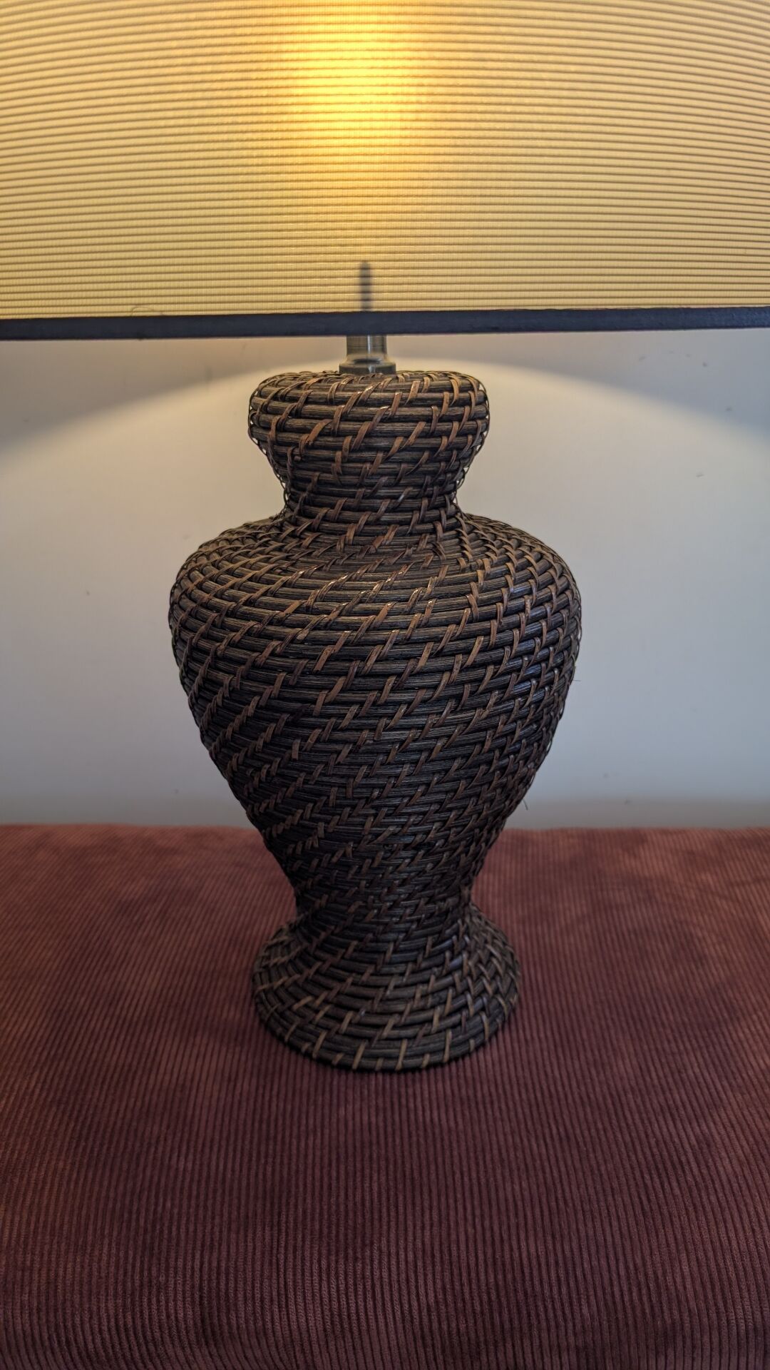 Vintage lamp in brown rattan with textured lampshade.