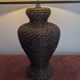 Vintage lamp in brown rattan with textured lampshade.