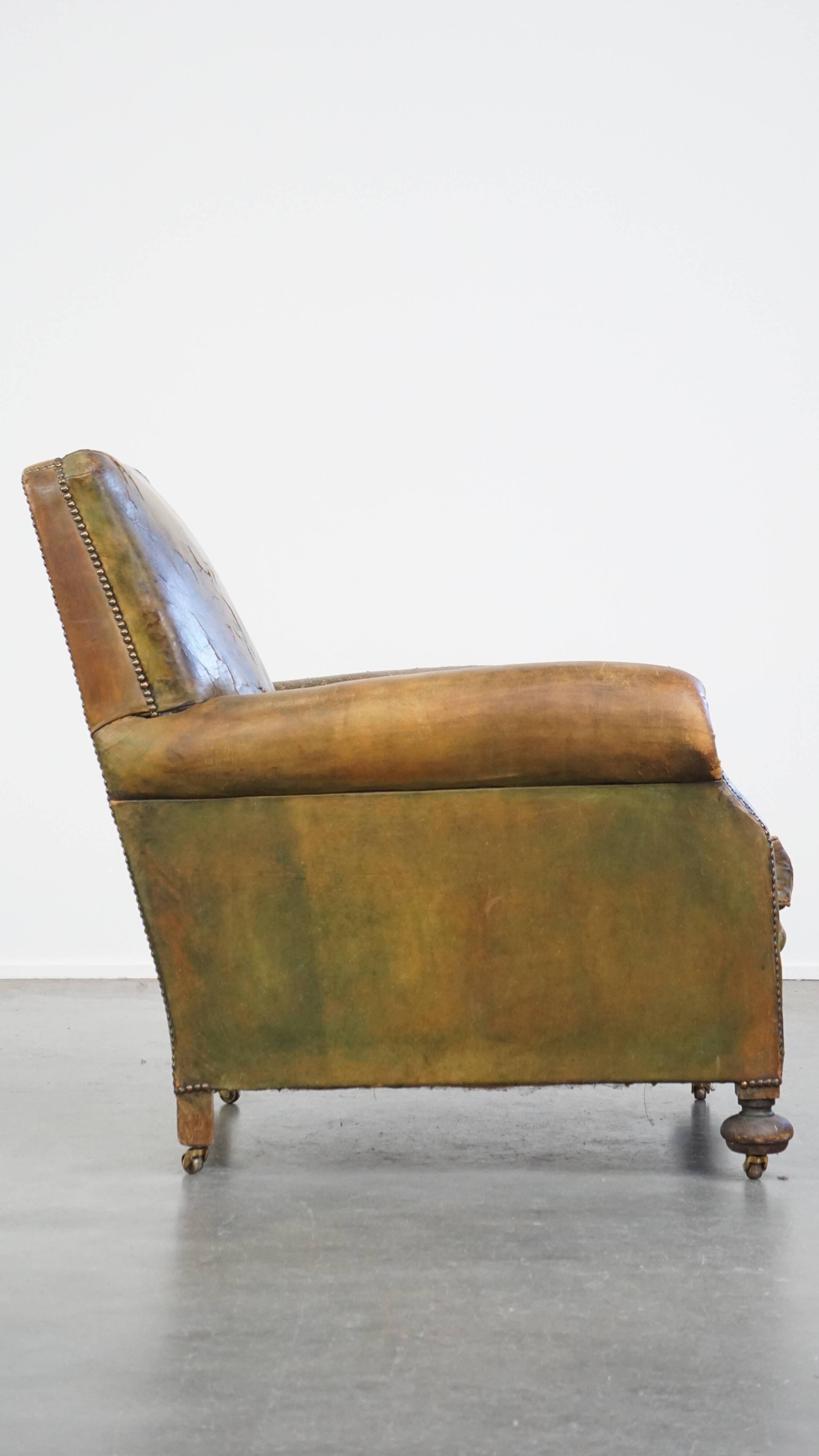 Green antique English cowhide leather armchair on wheels