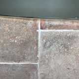 Vintage 1960 free-form mirror known as a retro mirror with a gold and black metal trim.