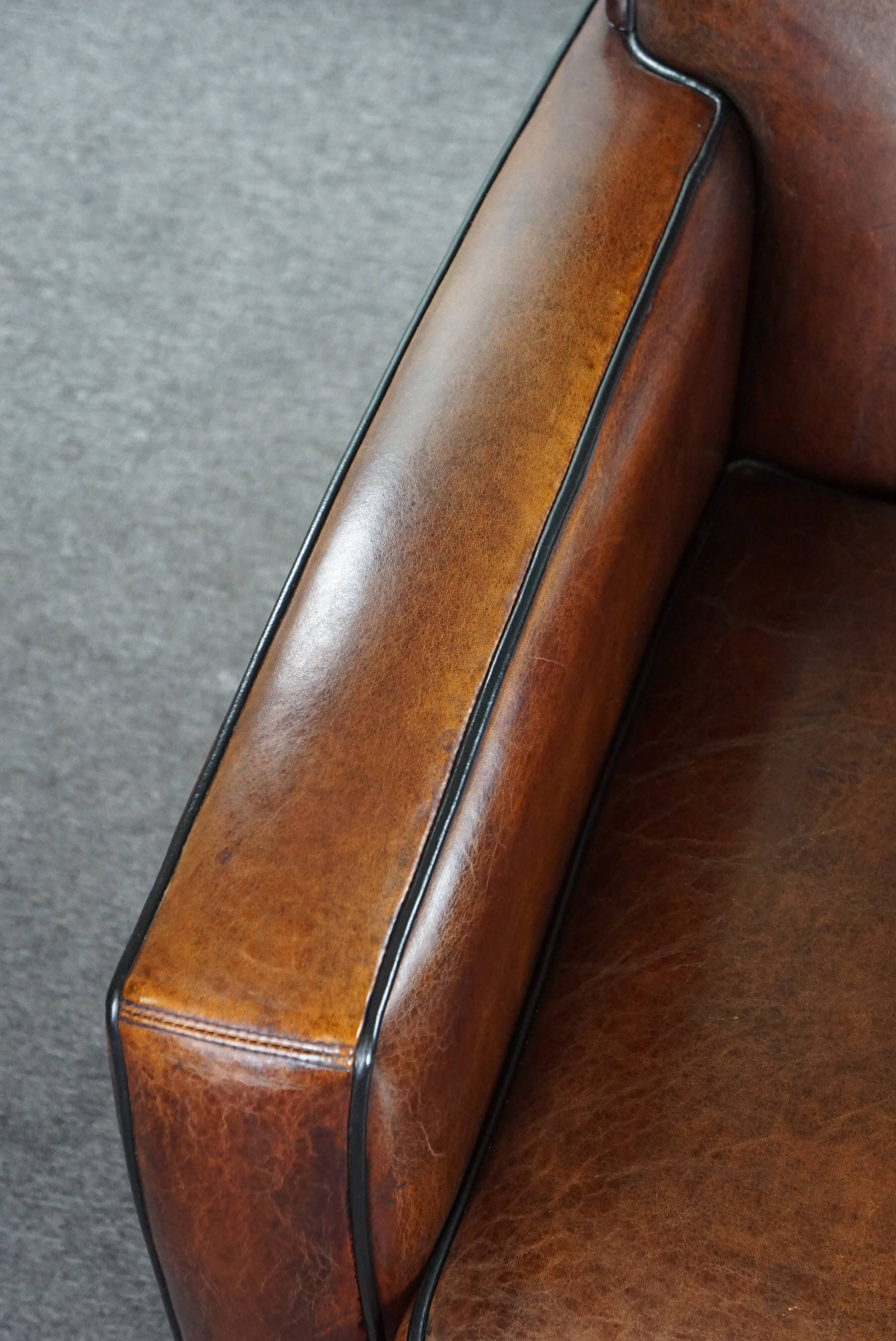 A very beautiful set of 2 Art Deco design armchairs in sheep leather