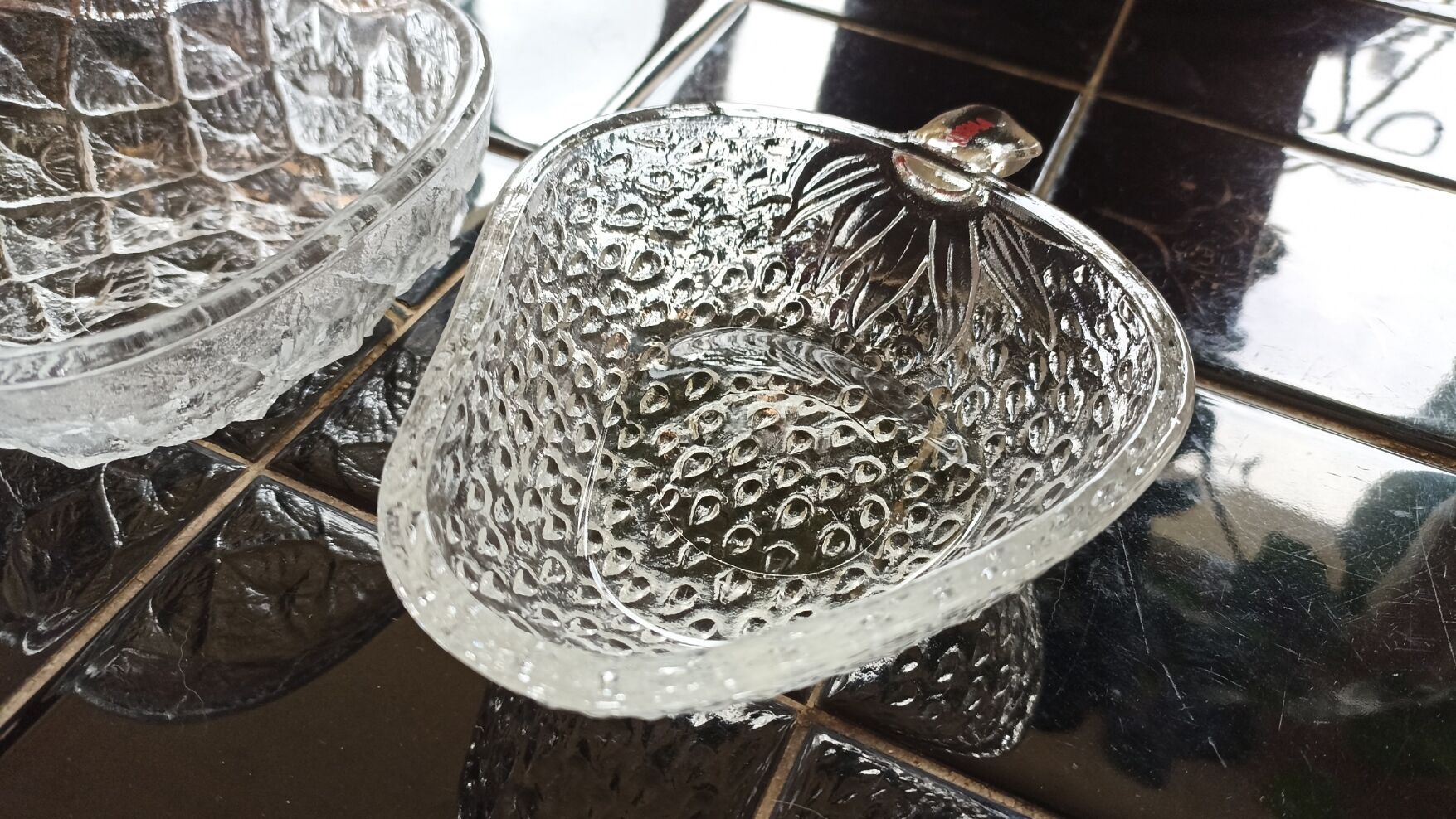 Two molded glass cups in the shape of strawberry and pineapple