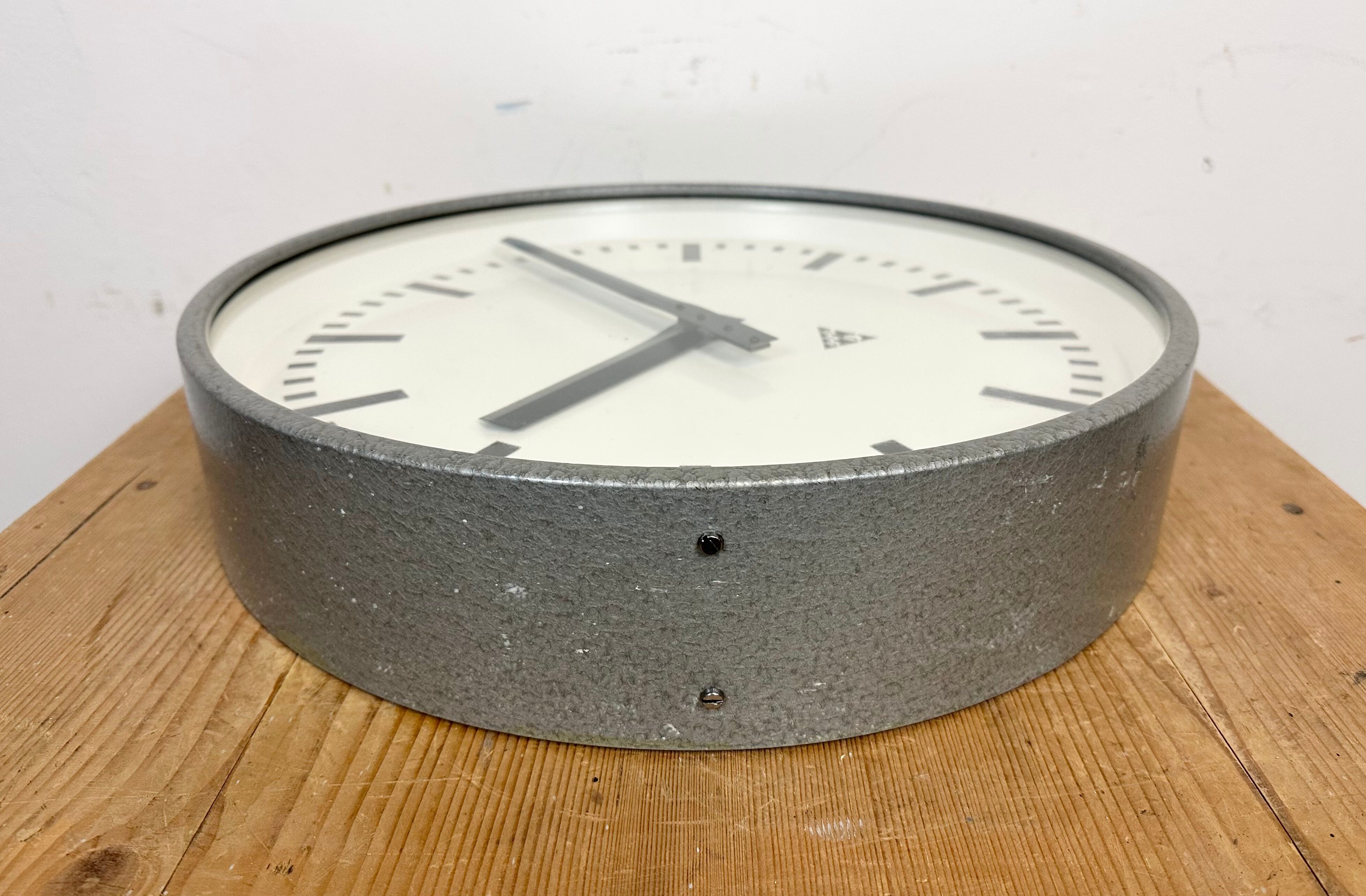 Grey industrial factory wall clock from pragotron, 1960s