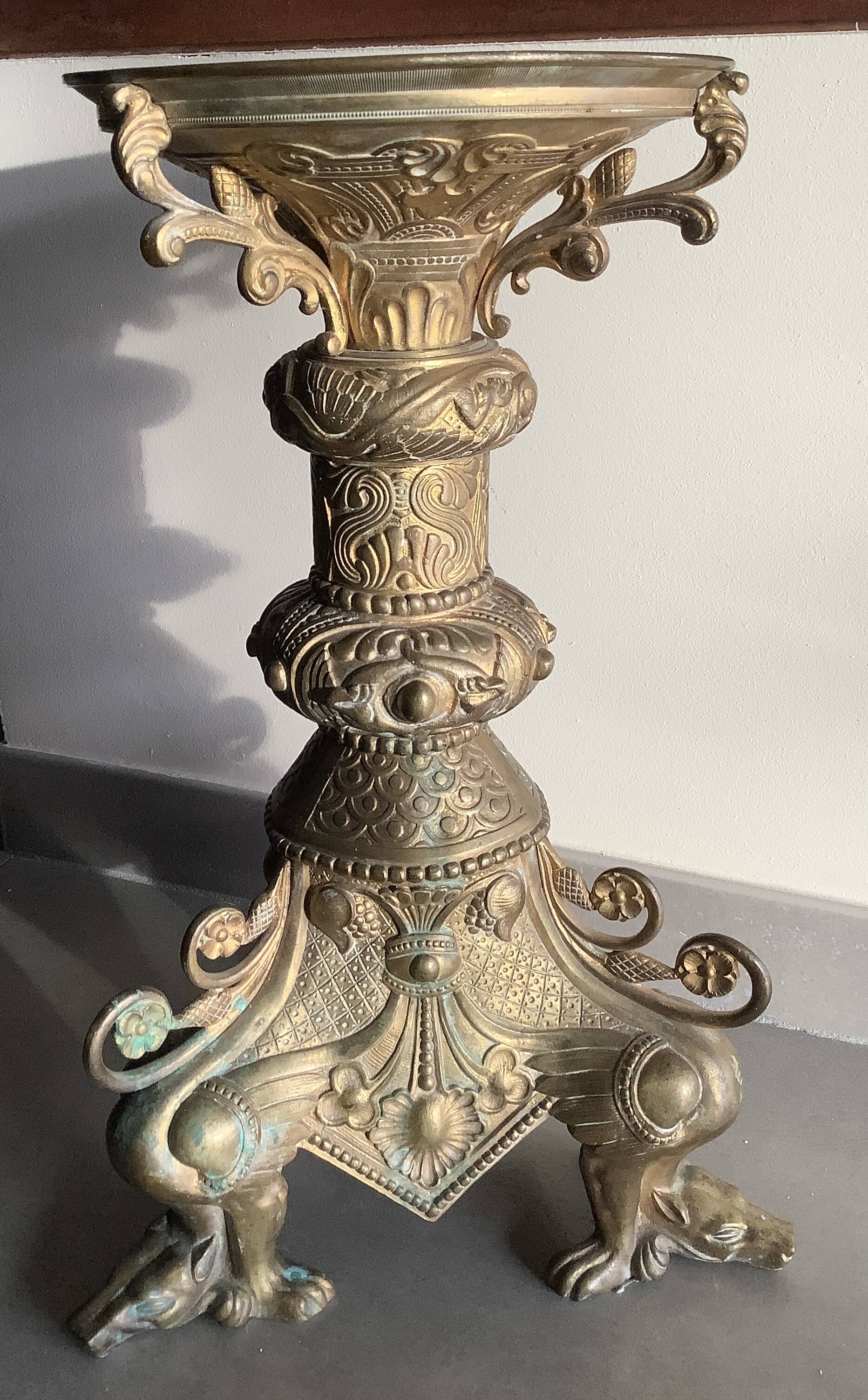 Large bronze candlestick with tripod and winged dog decoration, 19th century.