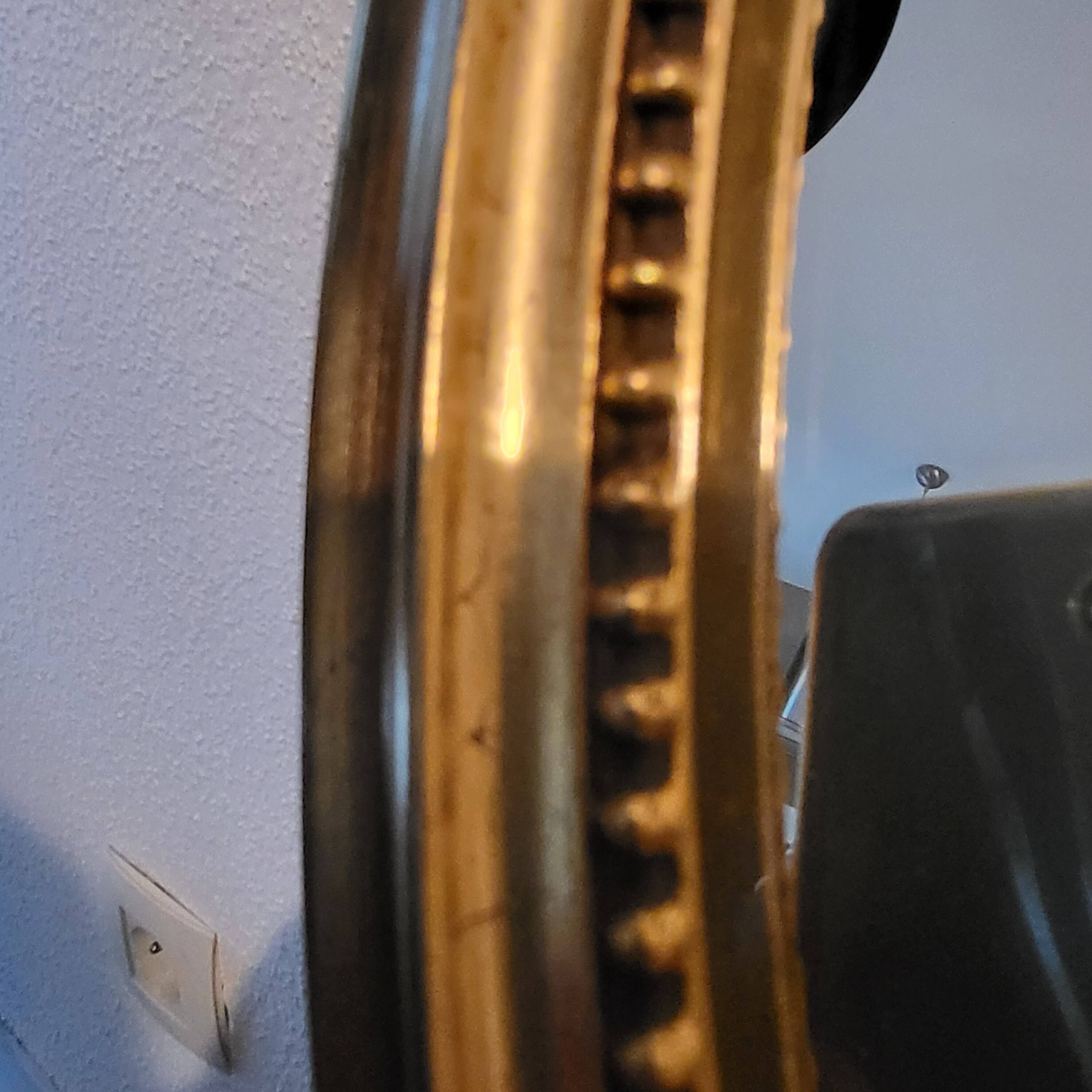 Oval mirror with golden wooden knot