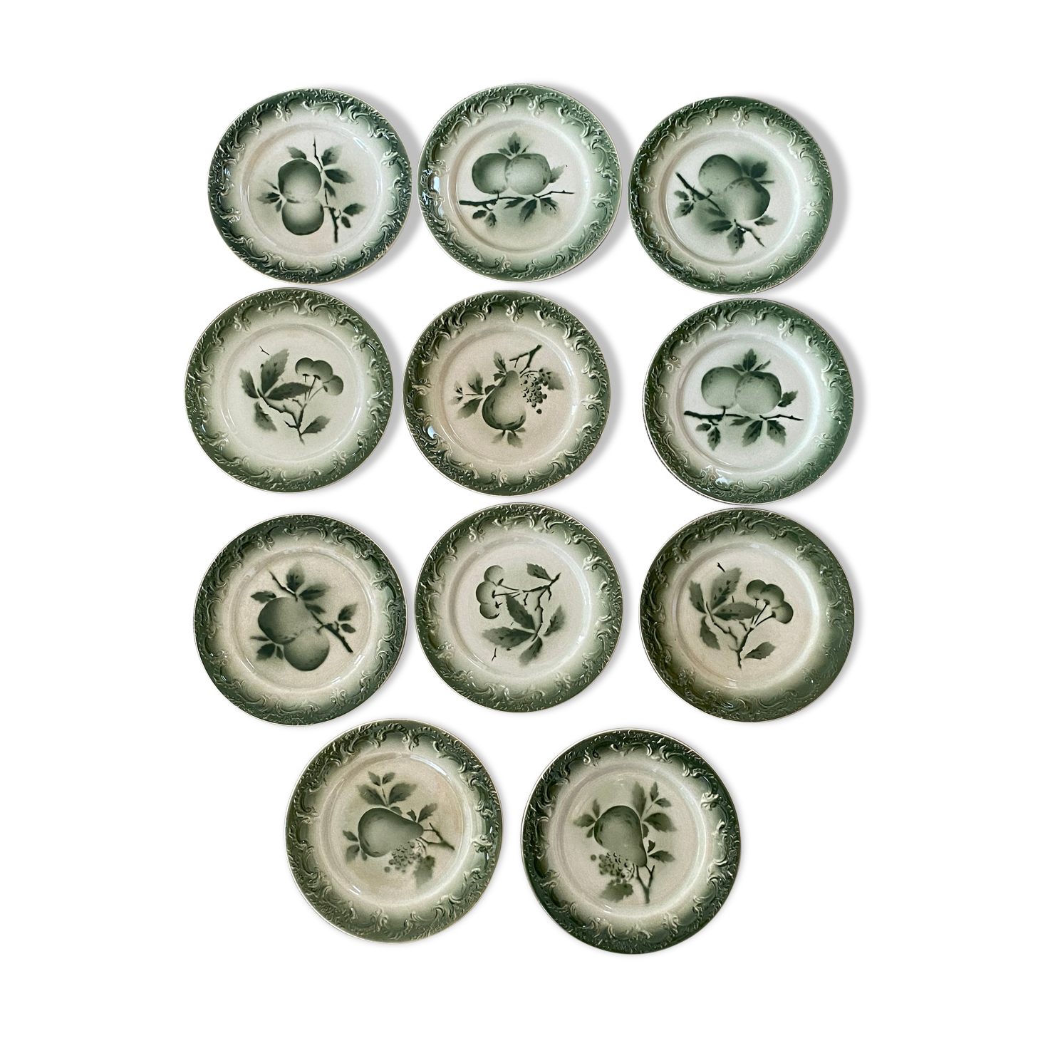11 old dessert plates from the Pexonne earthenware factory, green and cream fruit decoration