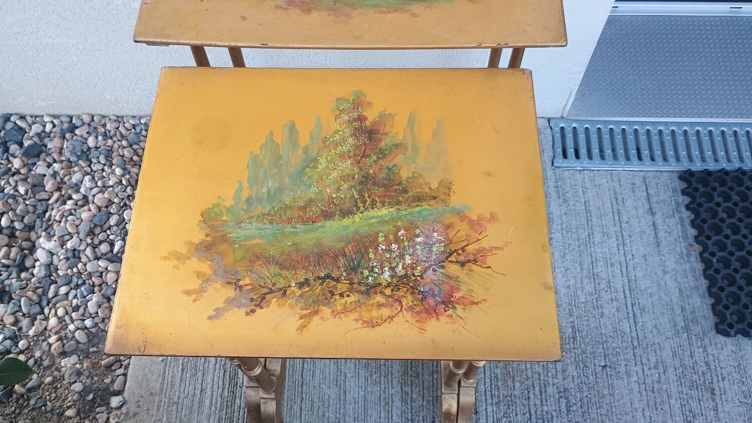 Sets of three nesting tables with painted landscape decorations in poplar.