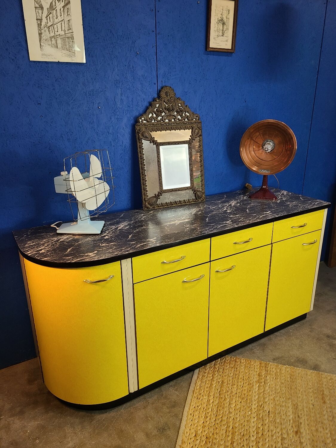 Vintage yellow sideboard, and black marble top.