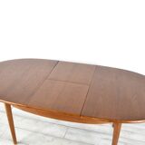 A stylish vintage teak danish influenced extending dining table for sale.  Supported on four slender