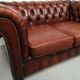Two-seater brown leather chesterfield sofa