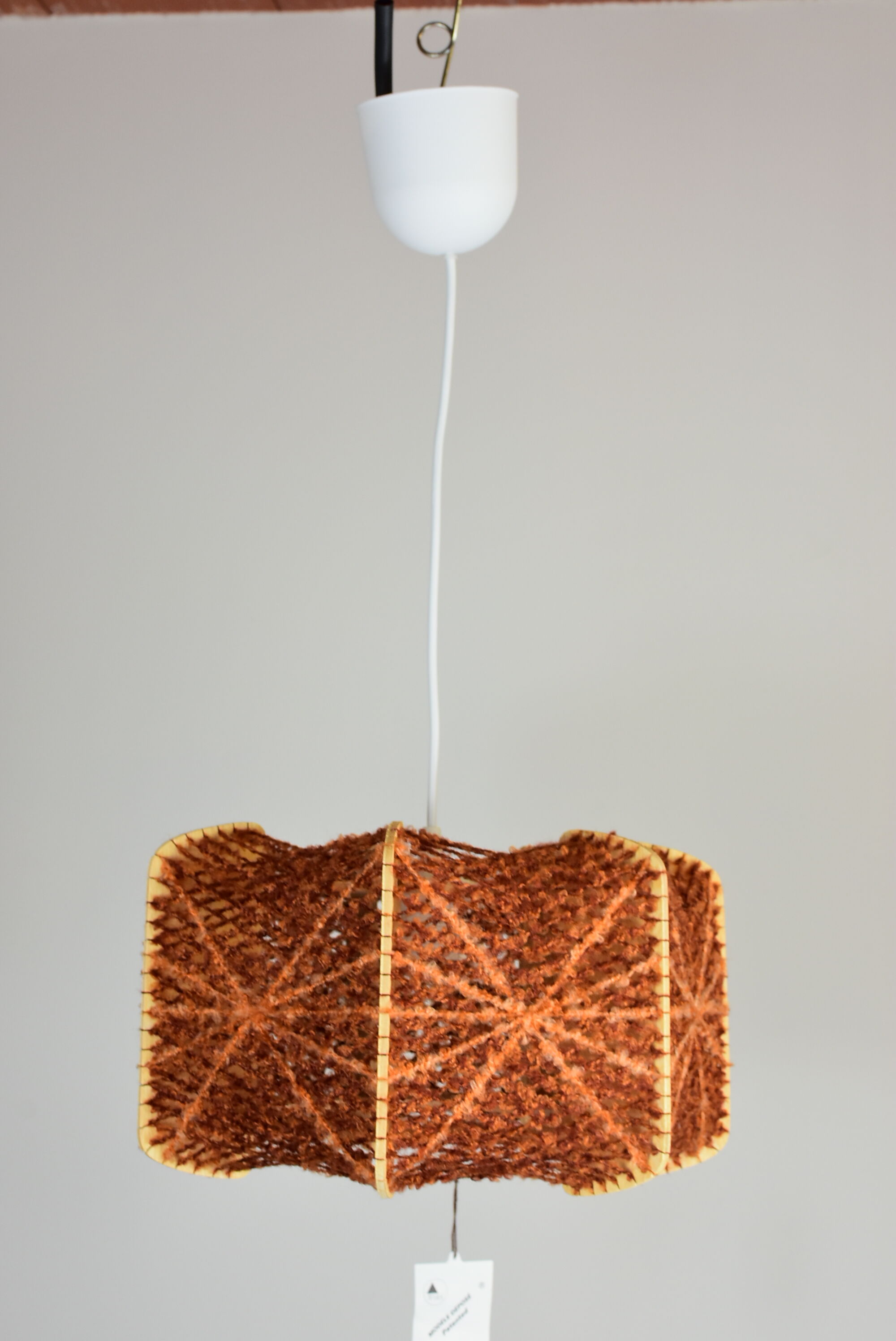 Brown wire and wood pendant light.