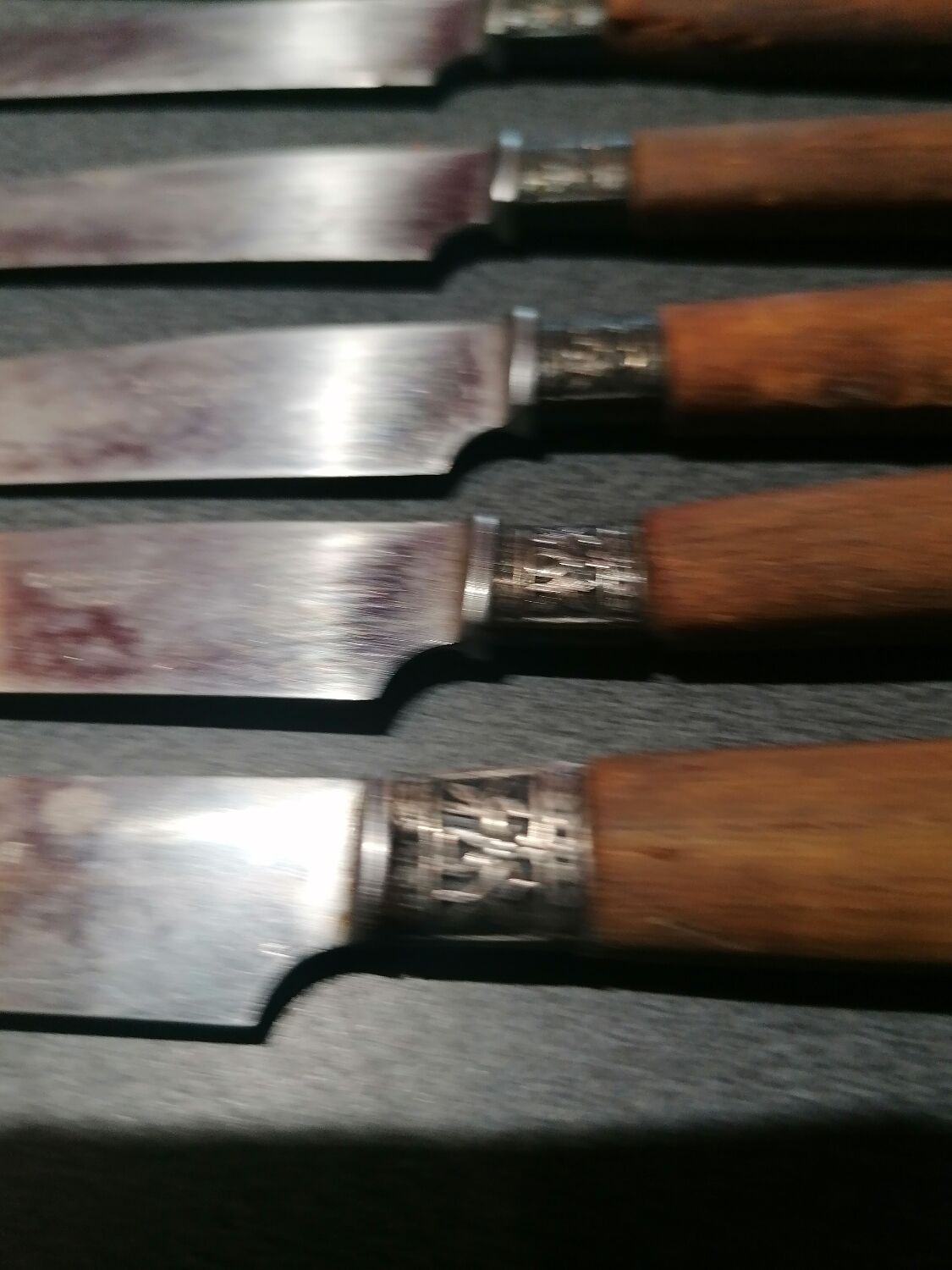 Old table knives and dessert knives, wooden handles, stainless steel blades