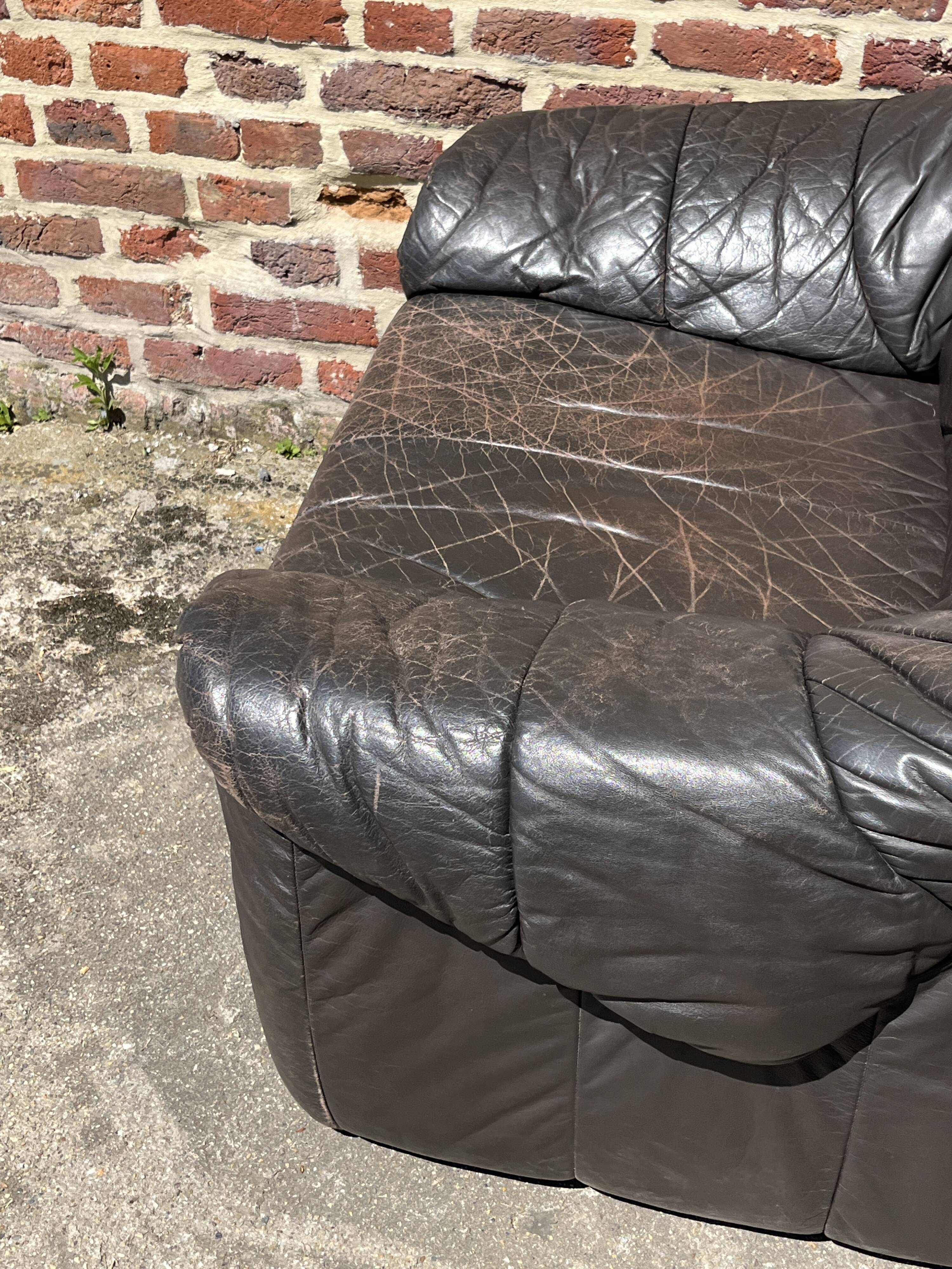Pair of patinated leather club armchairs