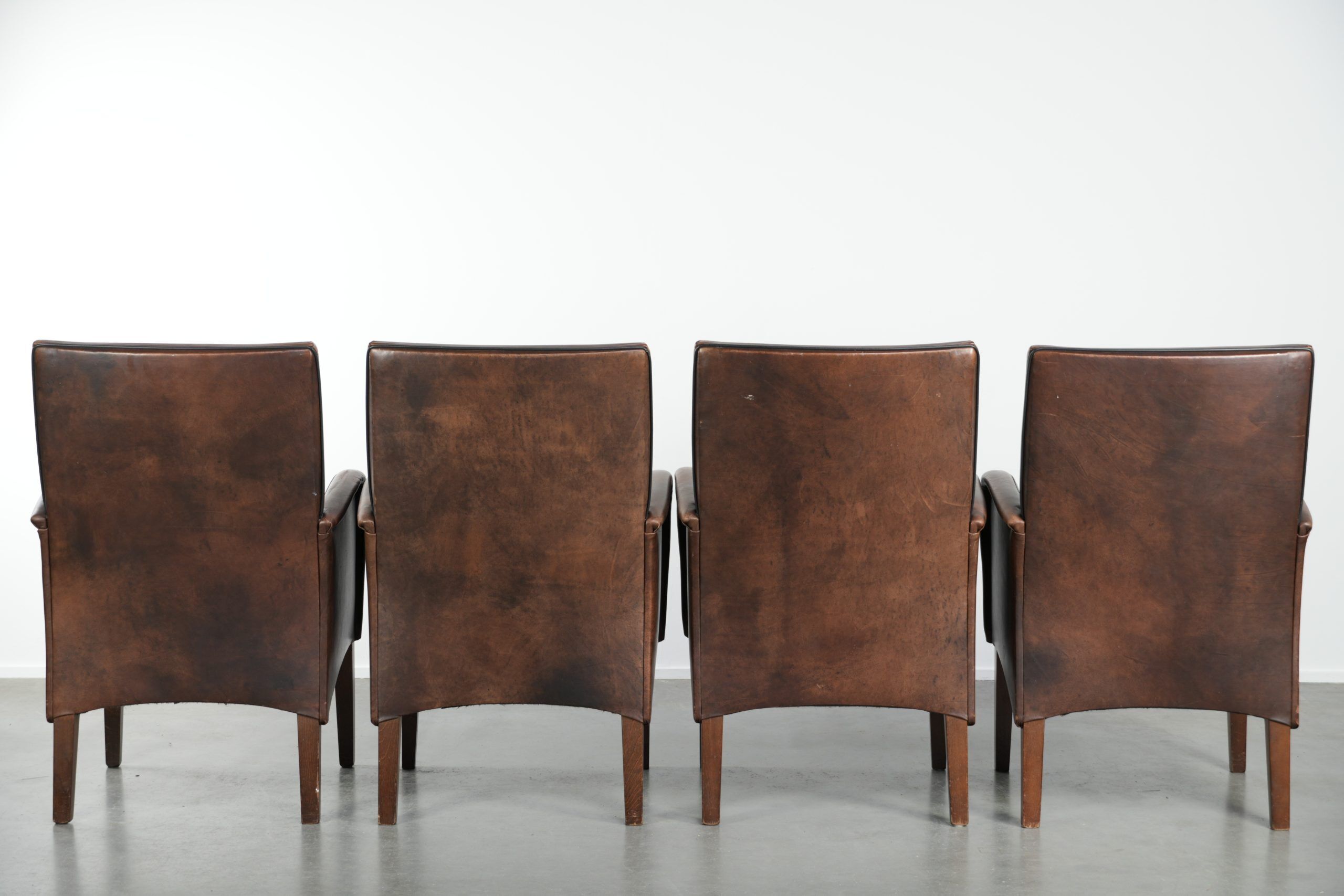 Set of 4 nicely finished dining chairs/side chairs with armrests made of cowhide leather