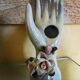 Hand holds jewelry or soliflore