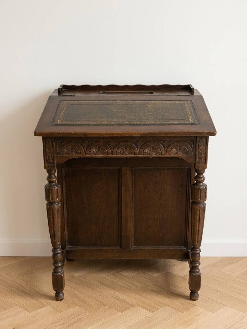 Antique wooden desk with a leather top.