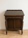 Antique wooden desk with a leather top.