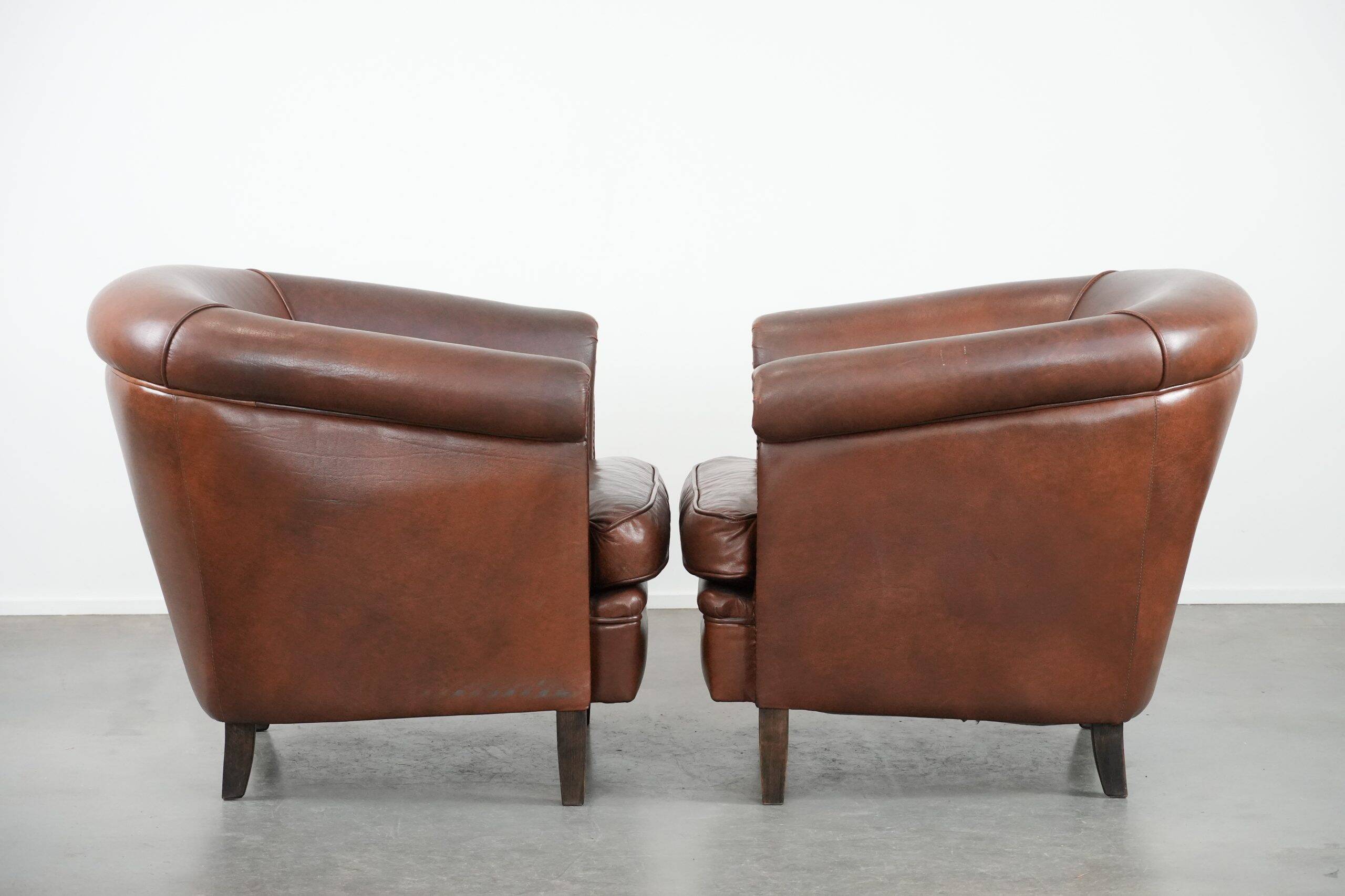 Unique set of two cognac-coloured cow leather club armchairs