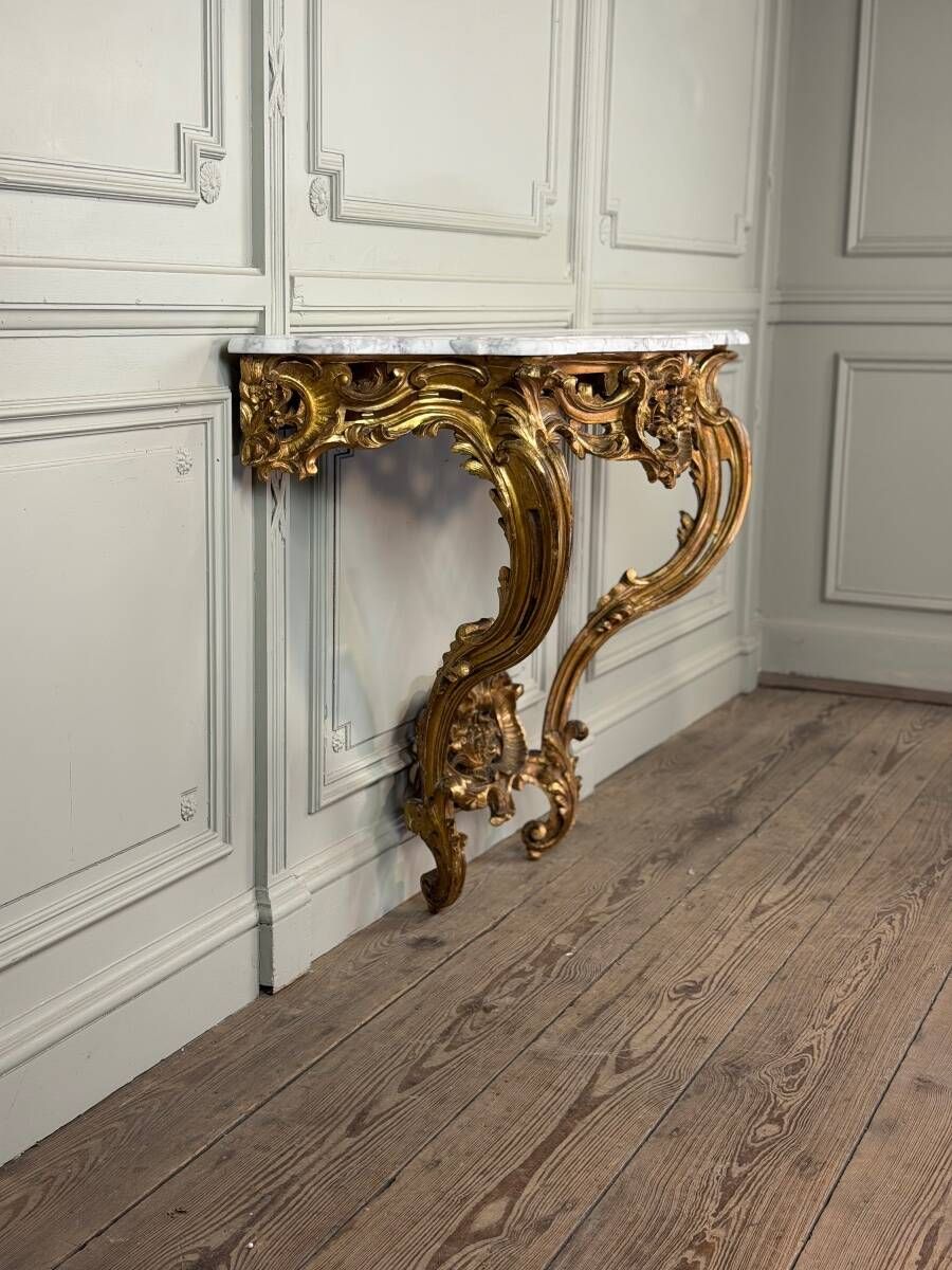 Louis XV style console in carved and gilded wood, circa 1880.