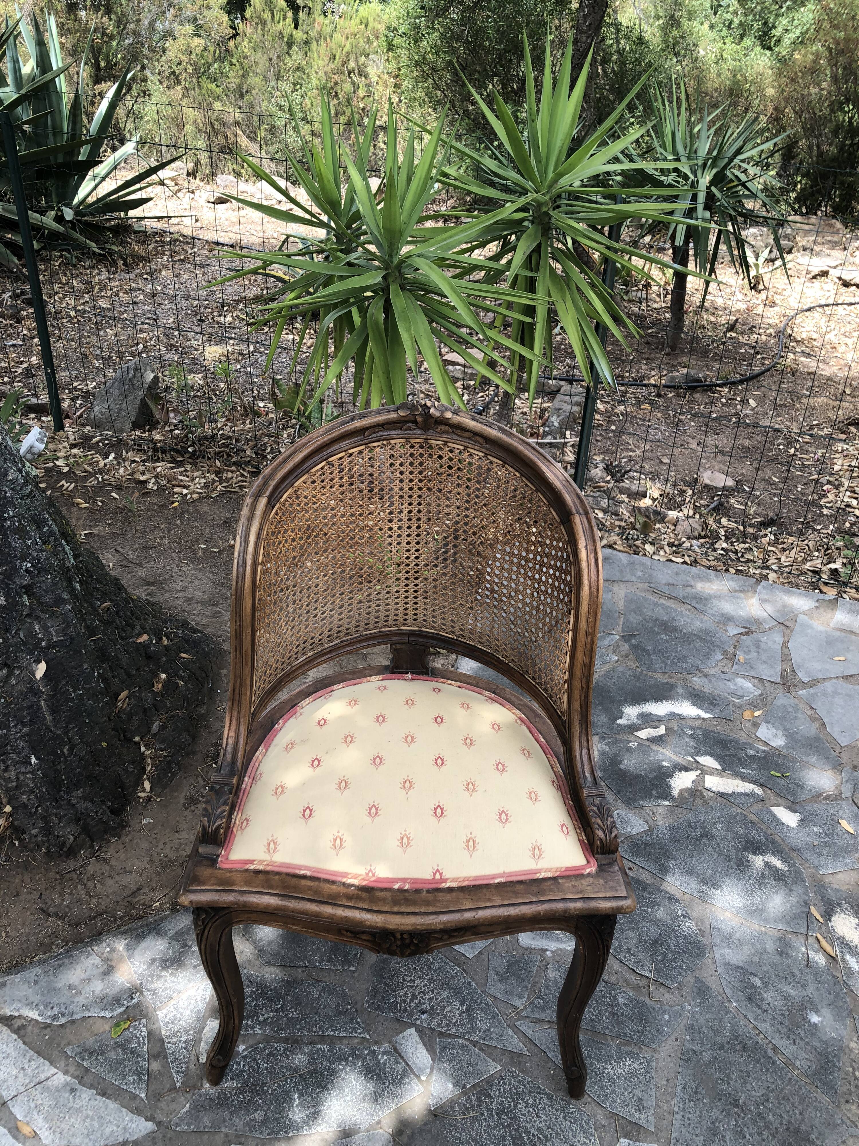 Old wooden armchair and cannage