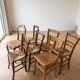 Set of 7 antique wooden and straw chairs.