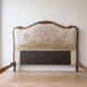 Double bed in Louis XVI style made of wood and floral fabric.