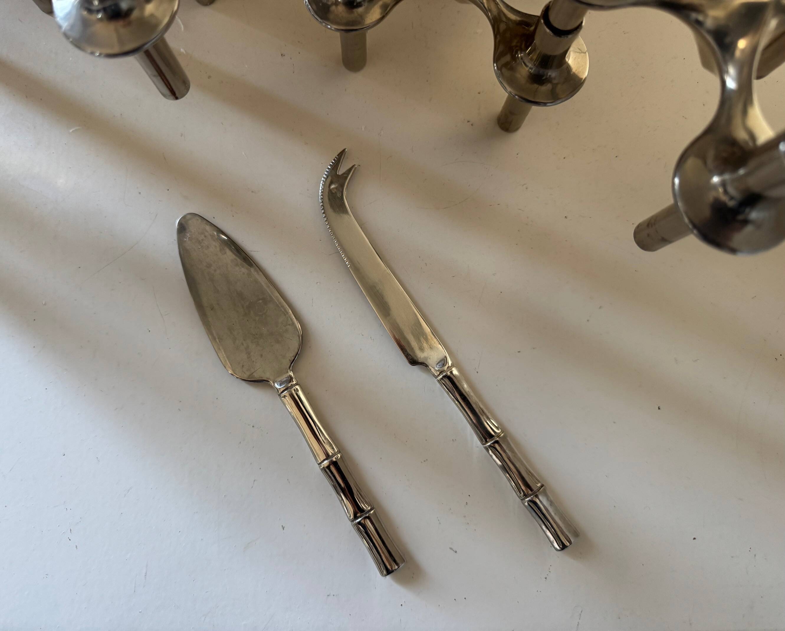 Golden metal cheese cutlery resembling bamboo